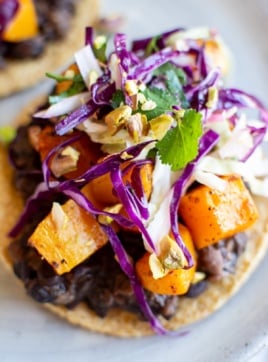 a roasted squash tostada topped with red cabbage