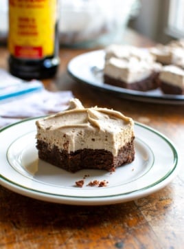 A brownie on a plate with a bite taken out of it.