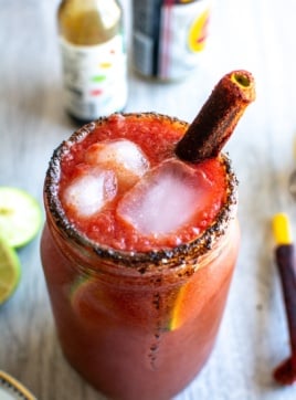 A michelada with a tamarind straw in it.