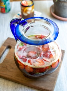 A glass pitcher filled with tamarind rum punch