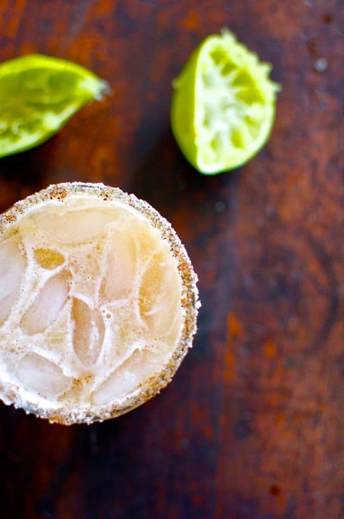 La Bruja is a tamarind margarita that is sweet and sour and perfect for Halloween. Dark añejo tequila, homemade tamarind simple syrup, and lots of lime.