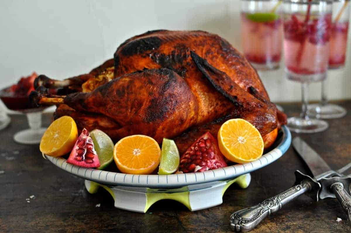 This Mexican-inspired Achiote Roasted Turkey recipe is rubbed with savory achiote paste and citrus then slow roasted to a beautiful bronze. #thanksgiving #turkey #Thanksgivingturkey #turkeyrecipe #holajalapeno