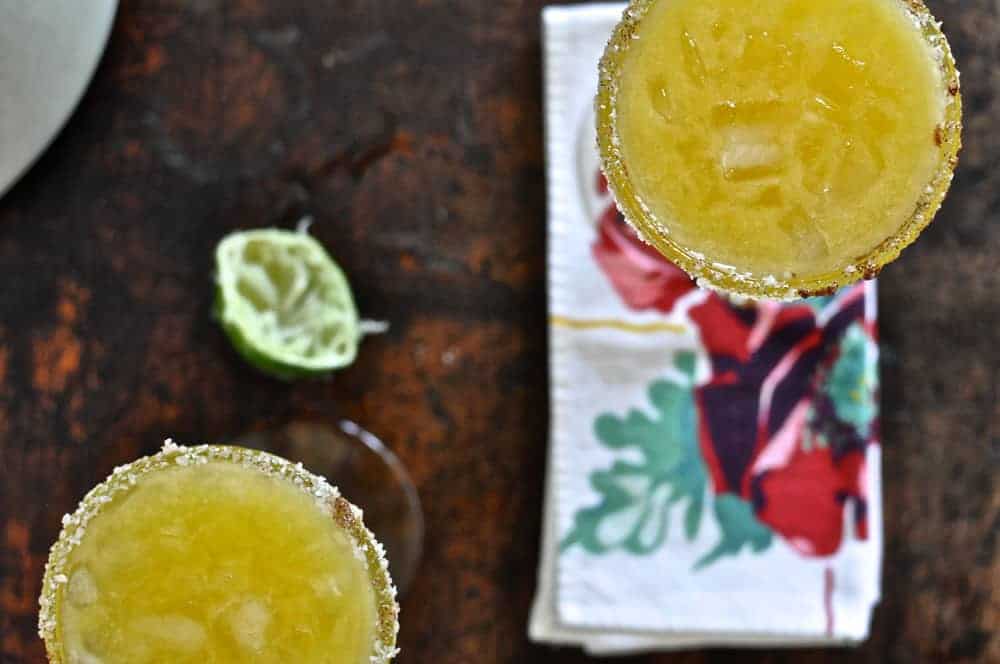 This spicy mango margarita is as easy as pie (or drinking a margarita). It's made with mango nectar, lime juice, tequila, and a sugar-chile rim!