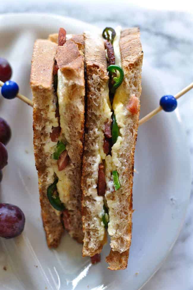 This jalapeño popper grilled cheese has everyone's favorite bar snack stuffed inside a grilled cheese sandwich. Cream cheese, Cheddar, jalapeños, and bacon.