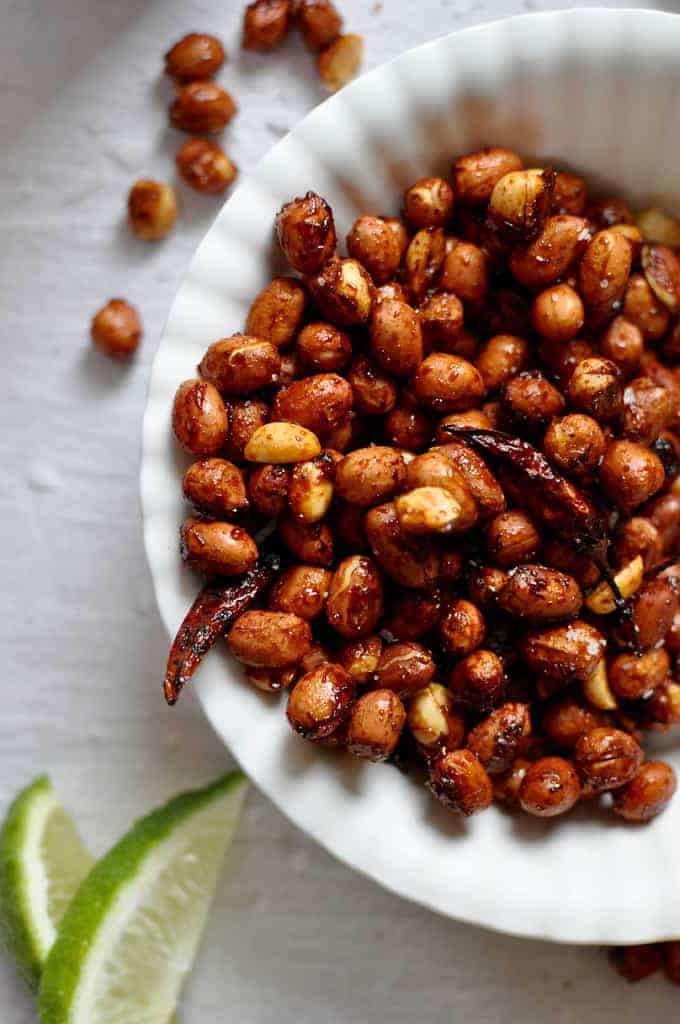 These chili lime roasted peanuts are tossed in an addictive mixture of chili, fresh lime zest, turbinado sugar, and salt then roasted to a golden brown.