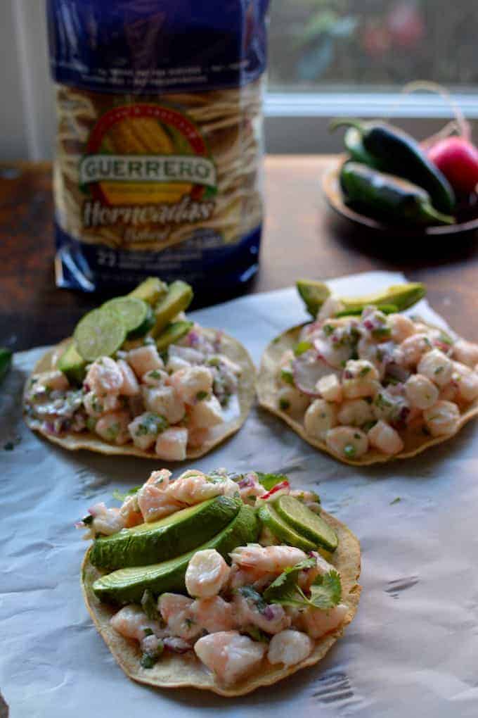 A super easy, ultra healthy shrimp ceviche tostada recipe with fresh squeezed lime juice, coconut milk, chiles, cilantro, and thinly sliced scallions.