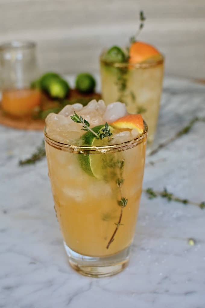 My Tangerine Thyme Margarita takes fresh-squeezed tangerine and lime juices and shakes it all around with herbal thyme syrup and tequila. A wintery margarita to celebrate the season's citrus AND National Margarita Day! #margarita #margaritarecipe #tangerinemargarita