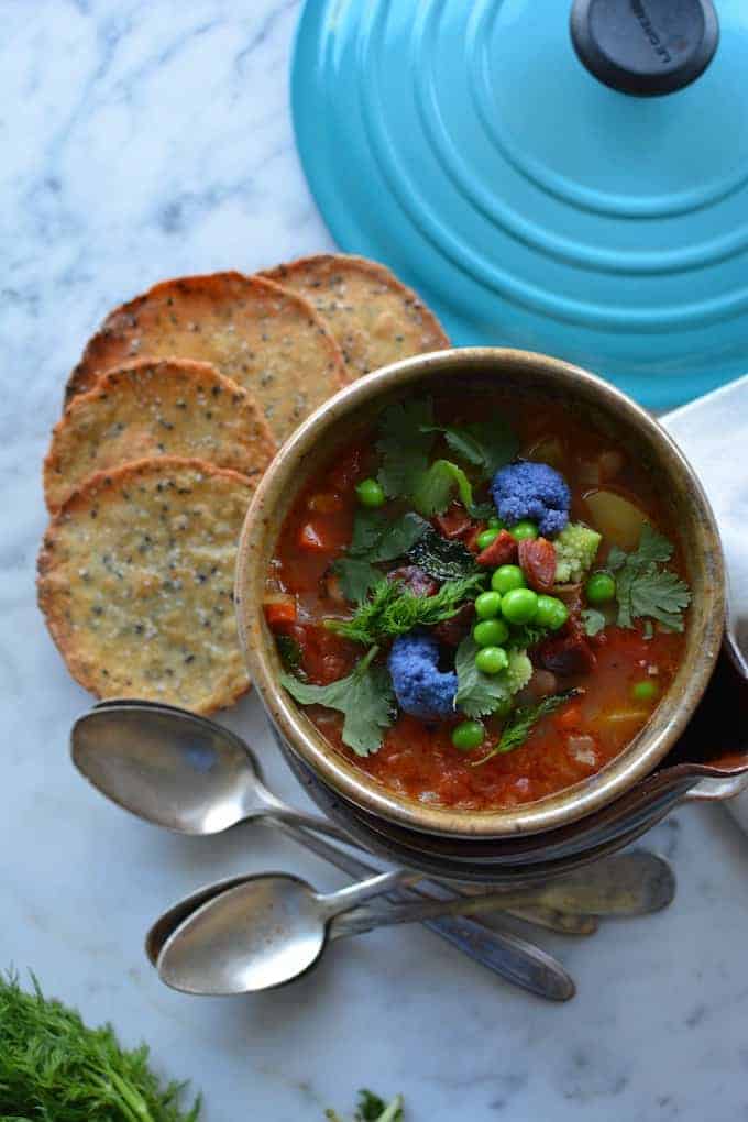 Chorizo, Pinto Bean, and Potato Minestrone is a Latin-inspired version of the traditional Italian soup. Filled with spring vegetables like sweet peas, purple cauliflower, and dill it is perfect for warming up those damp spring nights. #minestrone #healthyMexican #healthysoup