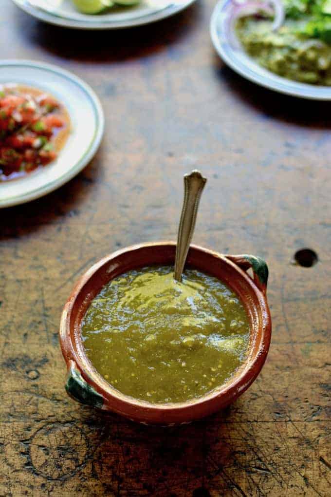 Homemade Salsa Verde is about the easiest thing in the world to make. Blended tomatillos, onion, jalapeños, and cilantro is all it takes to make a swoon-worthy salsa your friends will die for. #salsaverde #tomatillosalsaverde #homemadesalsaverde
