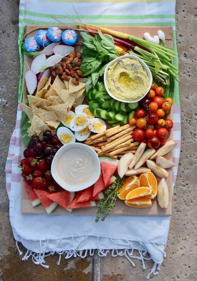 Platter ideas abound but this Pool Party Platter is the best way to satisfy poolside grazing with lots of fresh fruit, veggies, dips, crunchy snacks, and energy-boosting nibbles like cheese, nuts, and hard-boiled eggs. #partyplatter #poolparty #platterideas #summerparty #healthysnacks