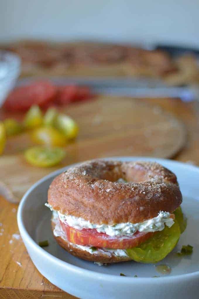 Worm Salt Bagels are just what they sound like: chewy homemade bagels made with worm salt or sal de gusano. Top with poblano chile cream cheese and tomatoes. #bagels #bagelrecipe #saldegusano #wormsalt #tomatorecipe