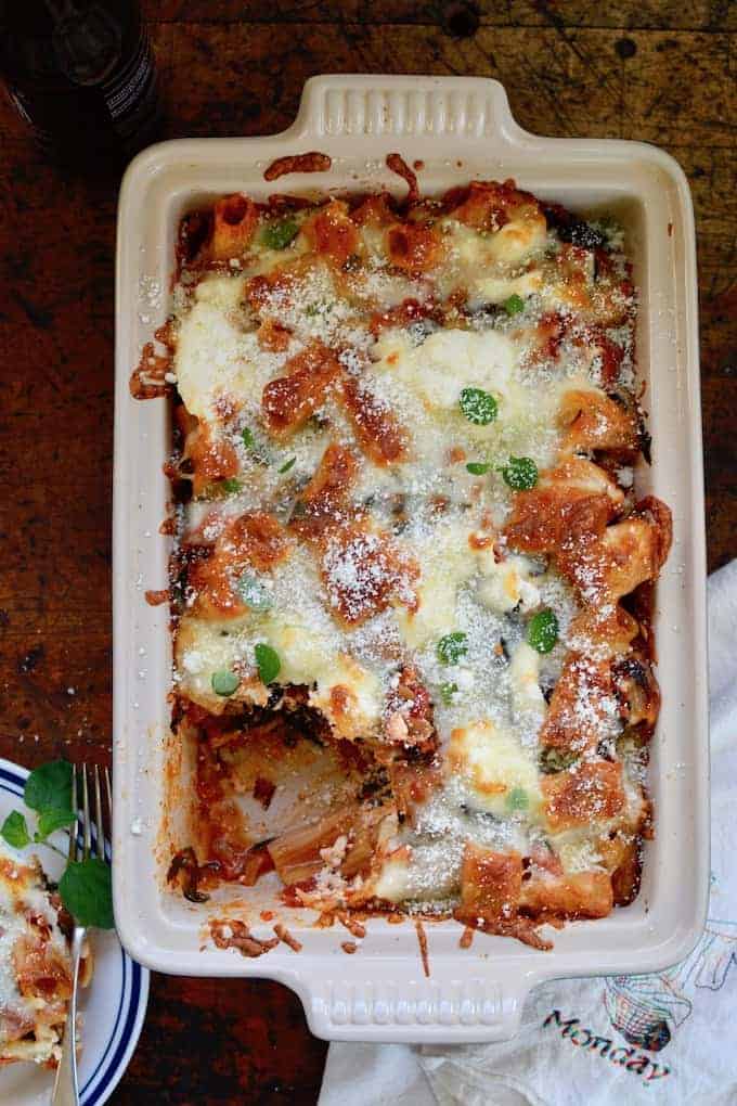 A cozy, vegetarian baked rigatoni that is loaded with six different vegetables and three kinds of cheese in a subtly spicy ancho chile-tomato sauce. So perfect for a cold winter night when you need something comforting but not too heavy and super easy to make in less than an hour! #vegetarian #bakedpasta #vegetarianpasta #vegetariandinner #potluckpasta #freezermeal