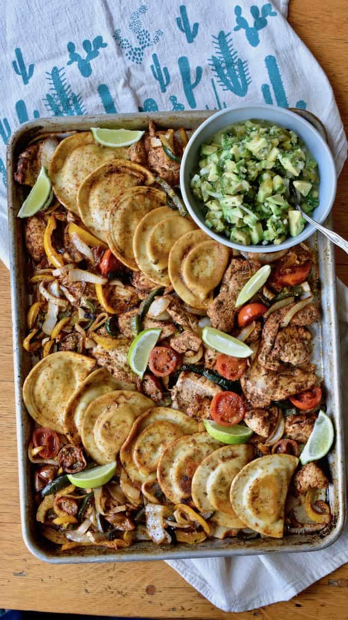 #ad| Our new favorite sheet pan chicken fajitas feature Cheddar Pierogies, chicken, and veggies tossed in chipotle spice mix + avocado pico de gallo for the win! #sheetpandinner #chickenfajitas #pierogies #avocado #sheetpanfajitas