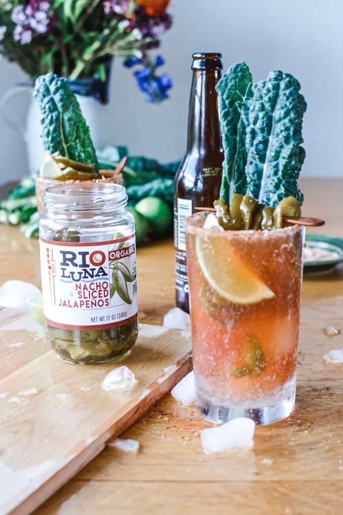 #ad|This is the best Spicy Jalapeño Michelada you will ever try, flavored with fiery pickling liquid from the peppers and a whole pile of jalapeños and lime. #michelada #jalapenos #beercocktail #beer #spicycocktail