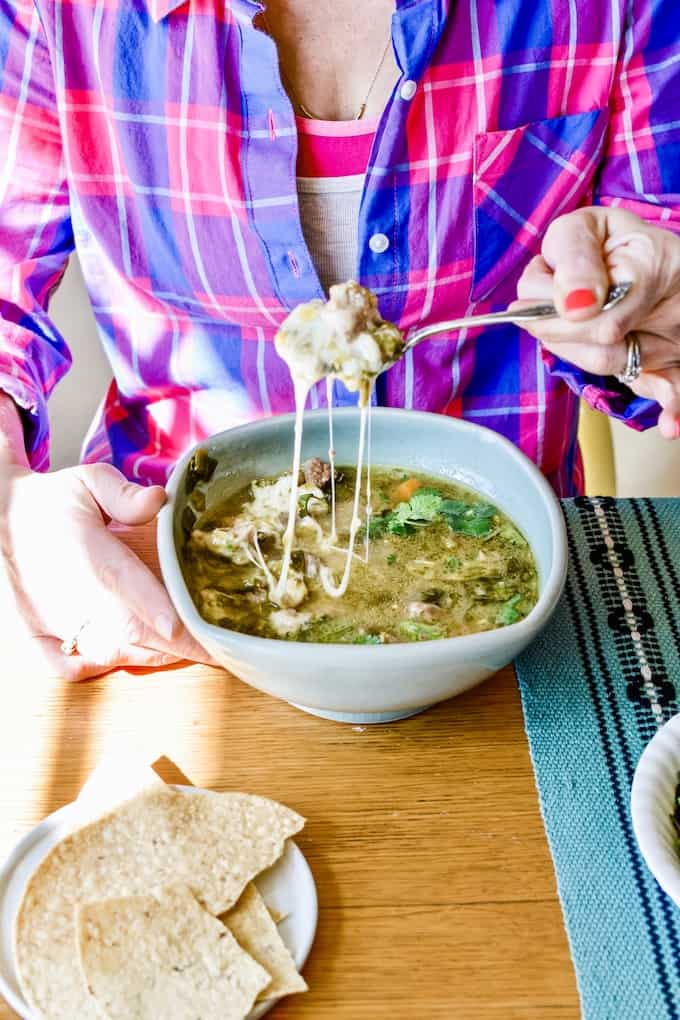 We're taking your favorite Instant Pot Pork Chili Verde recipe up a notch with handfuls of melty mozzarella cheese in each bowl for supreme chili status. #instantpot #porkchiliverde #instantpotchili #pork #cheese