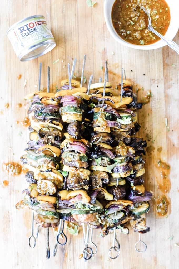 Grilled veggie skewers are the perfect way to celebrate summer produce, especially when drizzled with a smoky green chile vinaigrette! #skewers #vegandinner #grilledvegetables #greenchiles #ad #holajalapeno