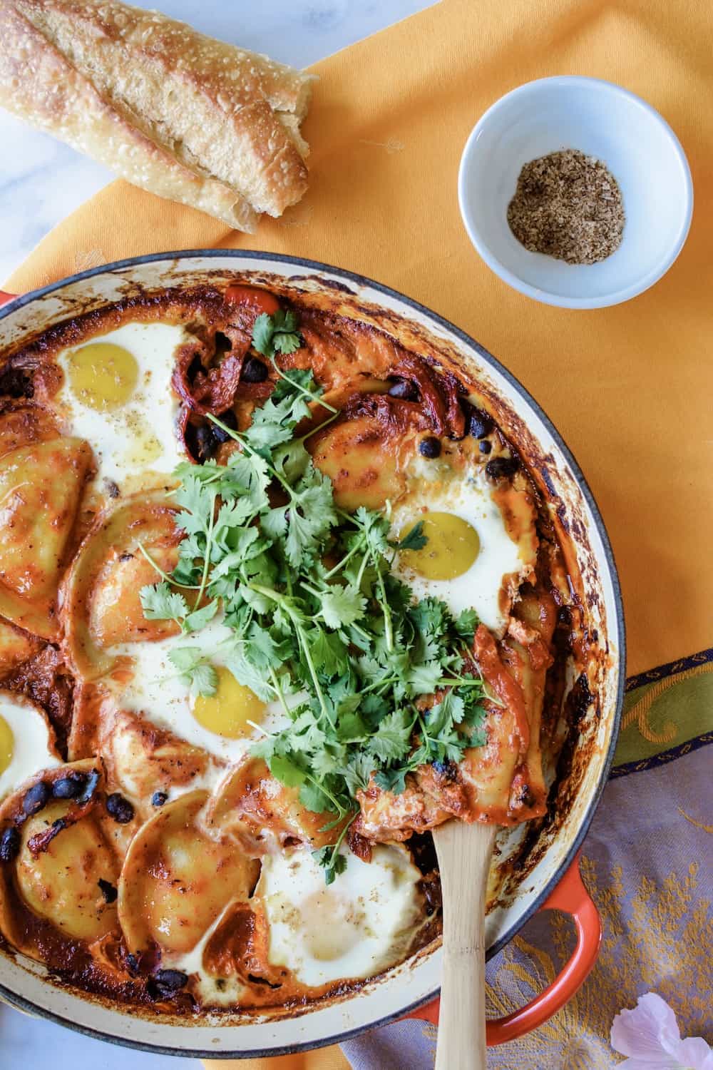 How to make baked eggs with Mrs. T's Pierogies, black beans, roasted red peppers, and silky baked eggs all in a guajillo-charred tomato ranchero sauce. #ad #MrsTPierogies #holajalapeno #bakedeggs #Mexicanbreakfast #rancherosauce
