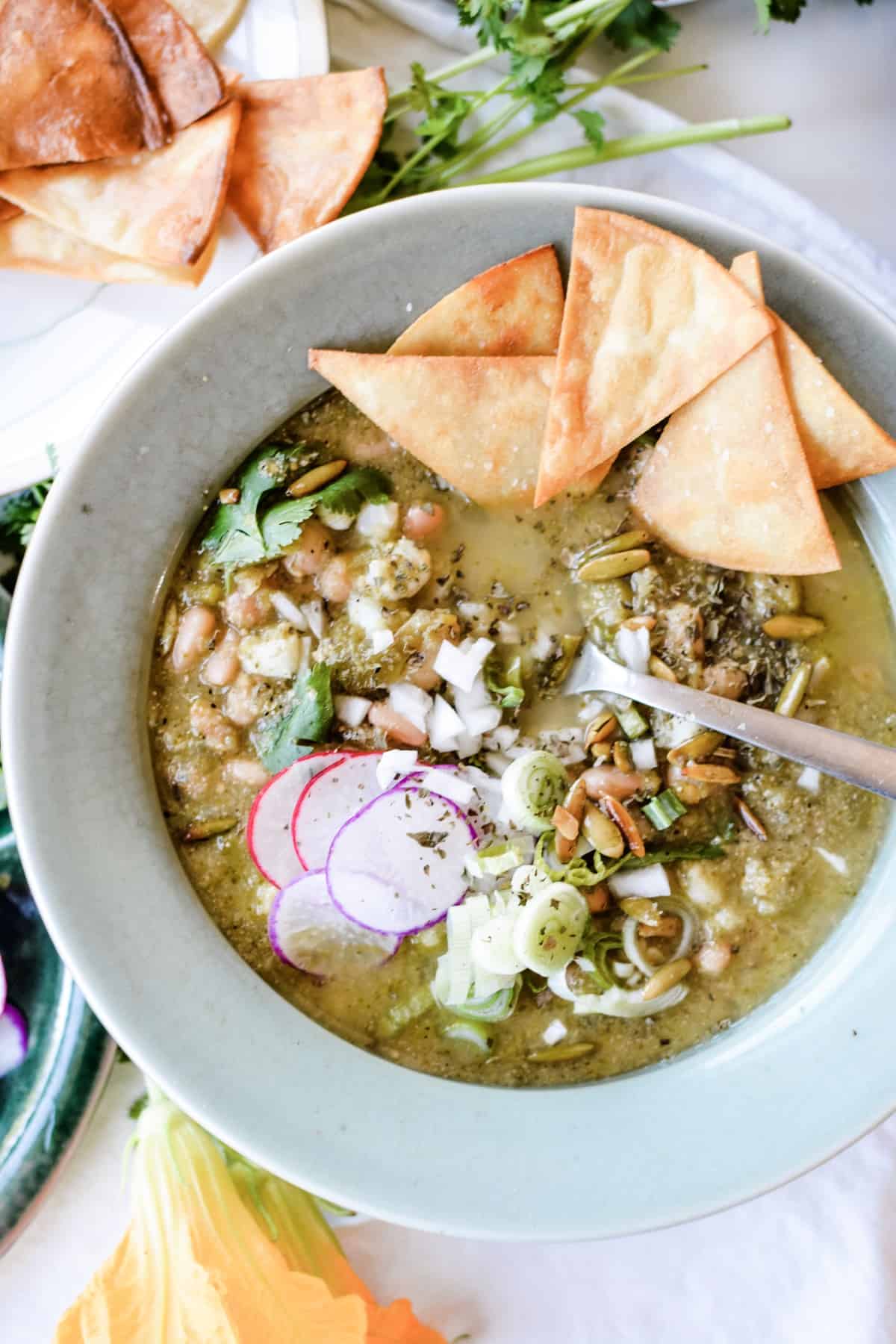 A spicy Pozole Verde that just so happens to be vegan. Made with green chiles, jalapeños, pinto beans and hominy. One of my favorite Mexican dinner ideas! #sponsored #holajalapeno #pozole #vegan