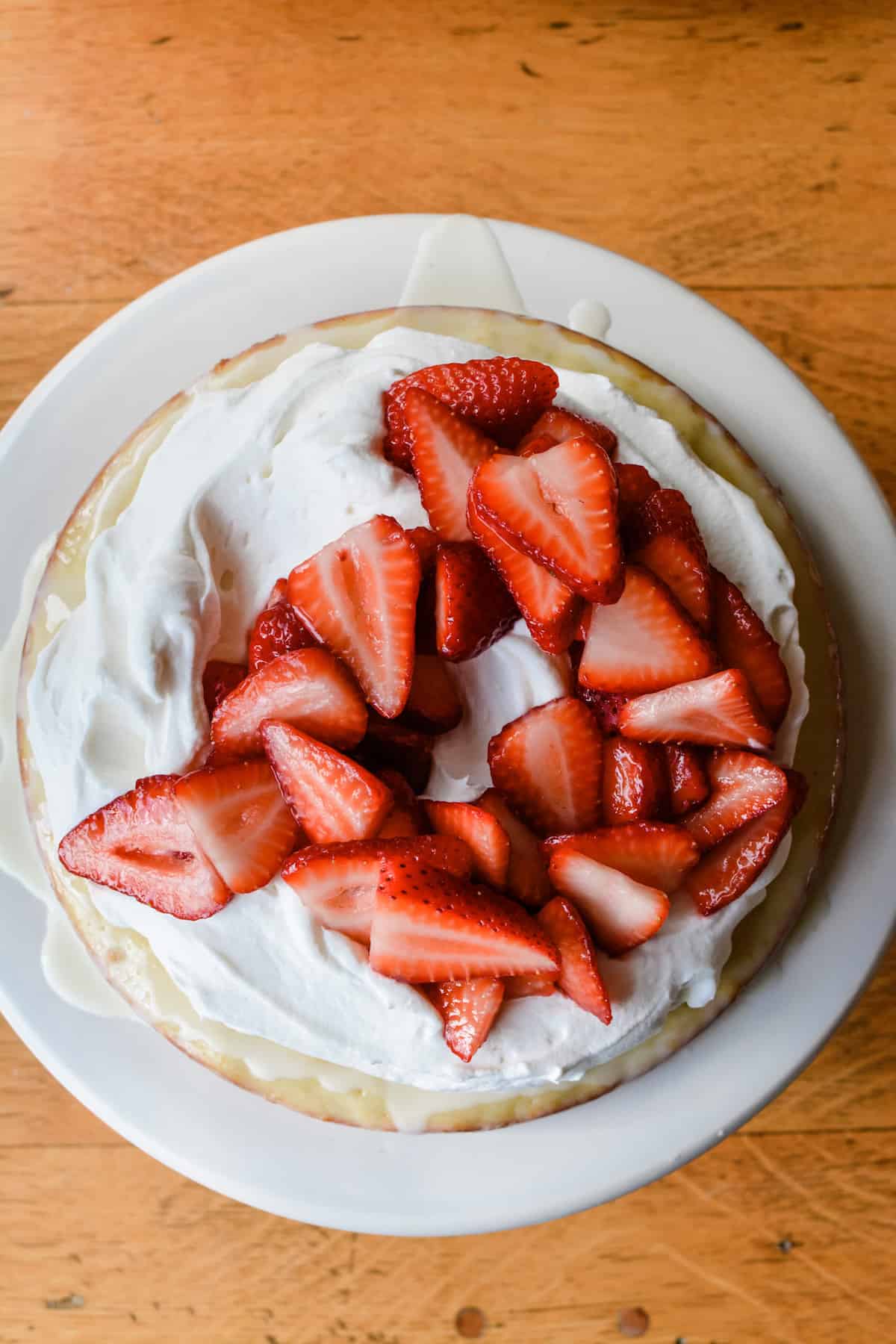 How to make a whole new take on strawberry shortcake! A Meyer lemon butter cake soaked in the classic tres leches cream and topped with juicy strawberries. #strawberryshortcake #meyerlemon #treslechescake #strawberryshortcakerecipe