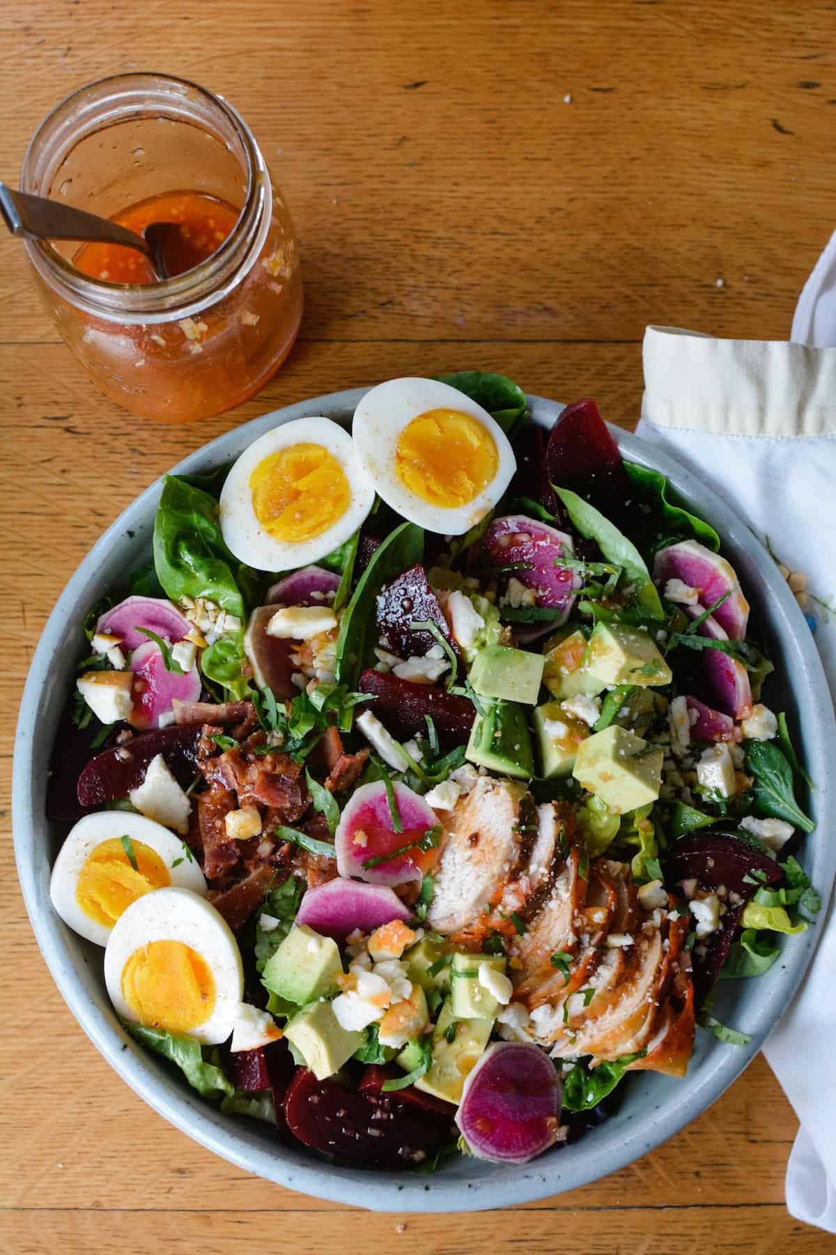 Autumn Harvest Cobb salad recipe with roasted beets and watermelon radish tossed in a tangy red wine vinegar dressing with smoked paprika, shallots and mustard. Top with crumbled feta, or keep it dairy-free! #cobbsalad #cobbsaladrecipe #fallsalad #salad