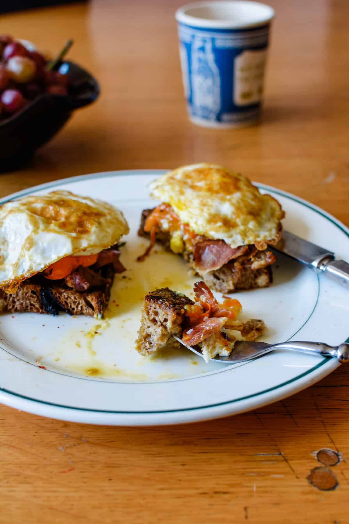Such a delicious breakfast recipe: Slices of rustic bread rubbed with garlic and topped with ham, roasted tomatoes and mushrooms, and a fried egg.