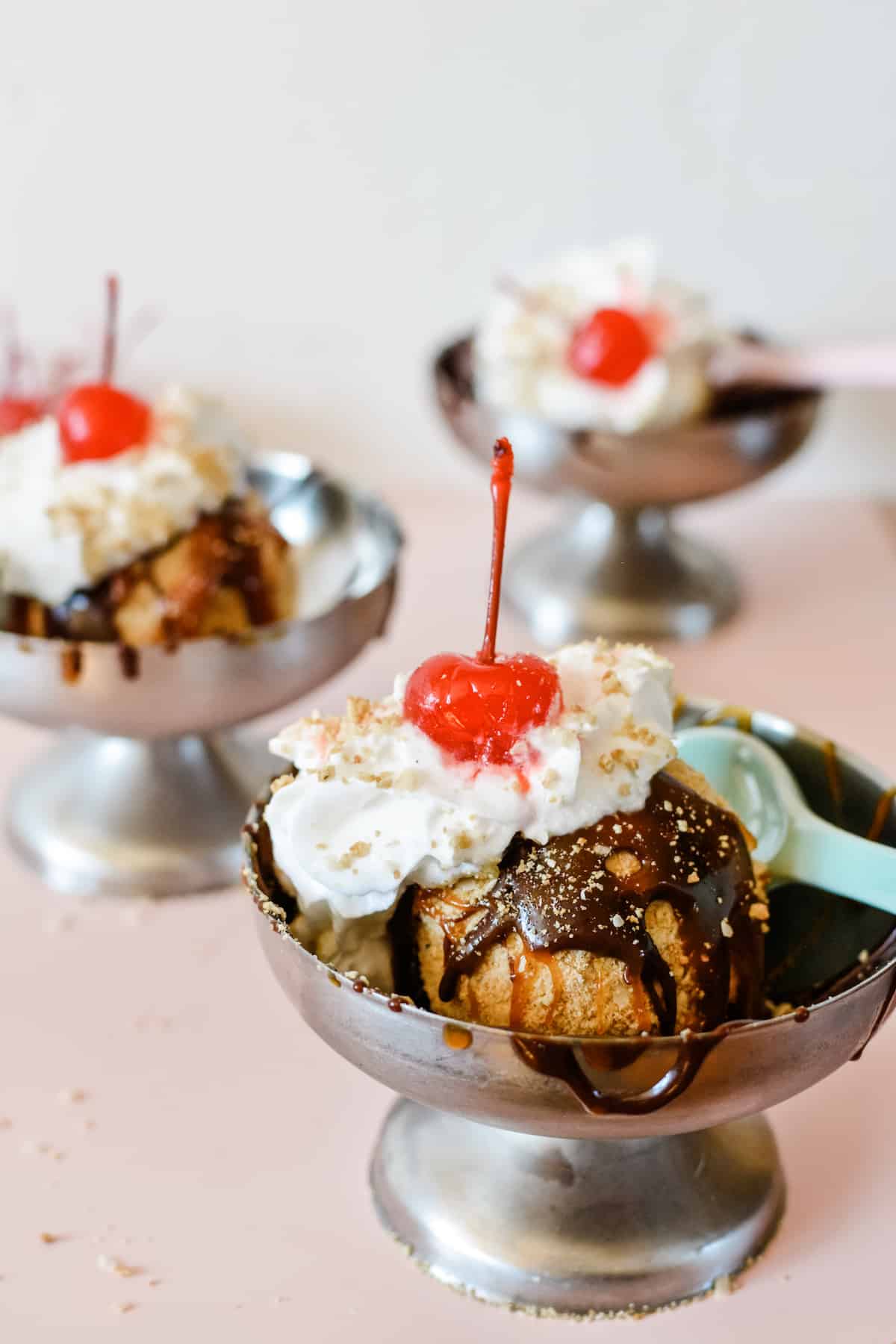 This simple, easy fried ice cream recipe actually requires no frying at all! Not missing is that golden, crispy, delicious cinnamon coating with flakes of sweetened coconut and creamy ice cream underneath. Can be made gluten-free and / or vegan! #friedicecream #easyfriedicecream #icecreamrecipe #easydessertrecipe