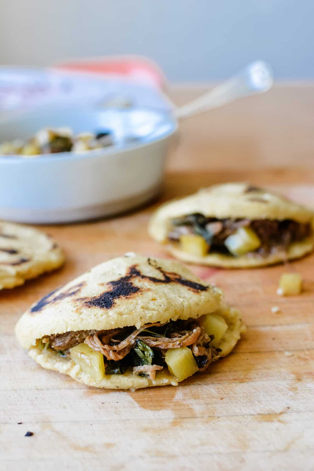 This delicious, gluten-free, dairy-free recipe for sweet potato and bacon gorditas can be stuffed with anything from braised beef to scrambled eggs! Flavored with roasted, mashed sweet potato and bits of crisp bacon, these are the most divine gorditas ever. Step-by-step instructions included! #gorditas #gorditarecipe #mexicanrecipe #mexicanfood