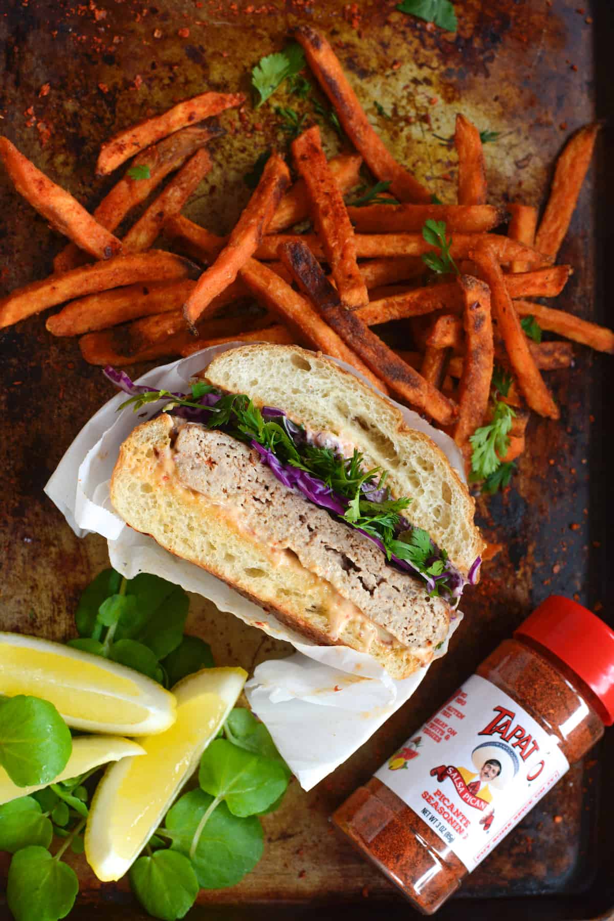 The BEST Turkey Burger recipe! This one is anything but boring, seasoned with Tapatio hot sauce, a simple spice blend, and Worcestershire with a little spicy mayo on top to boot. Serve the turkey burger with sweet potato fries and a simple Cilantro-Lime Slaw for an easy, healthy, and delicious dinner. #turkeyburgerrecipe #turkeyburger #spicyturkeyburger #tapatio