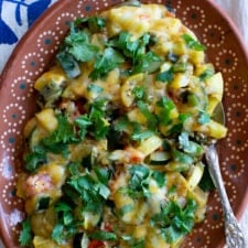 Zucchini is anything but boring when when given the Mexican treatment of a quick sauté then a showering of melty cheese like this classic Calabacitas recipe. #calabacitas #zucchinirecipe #vegetarianmexican #mexicanfood #holajalapeno