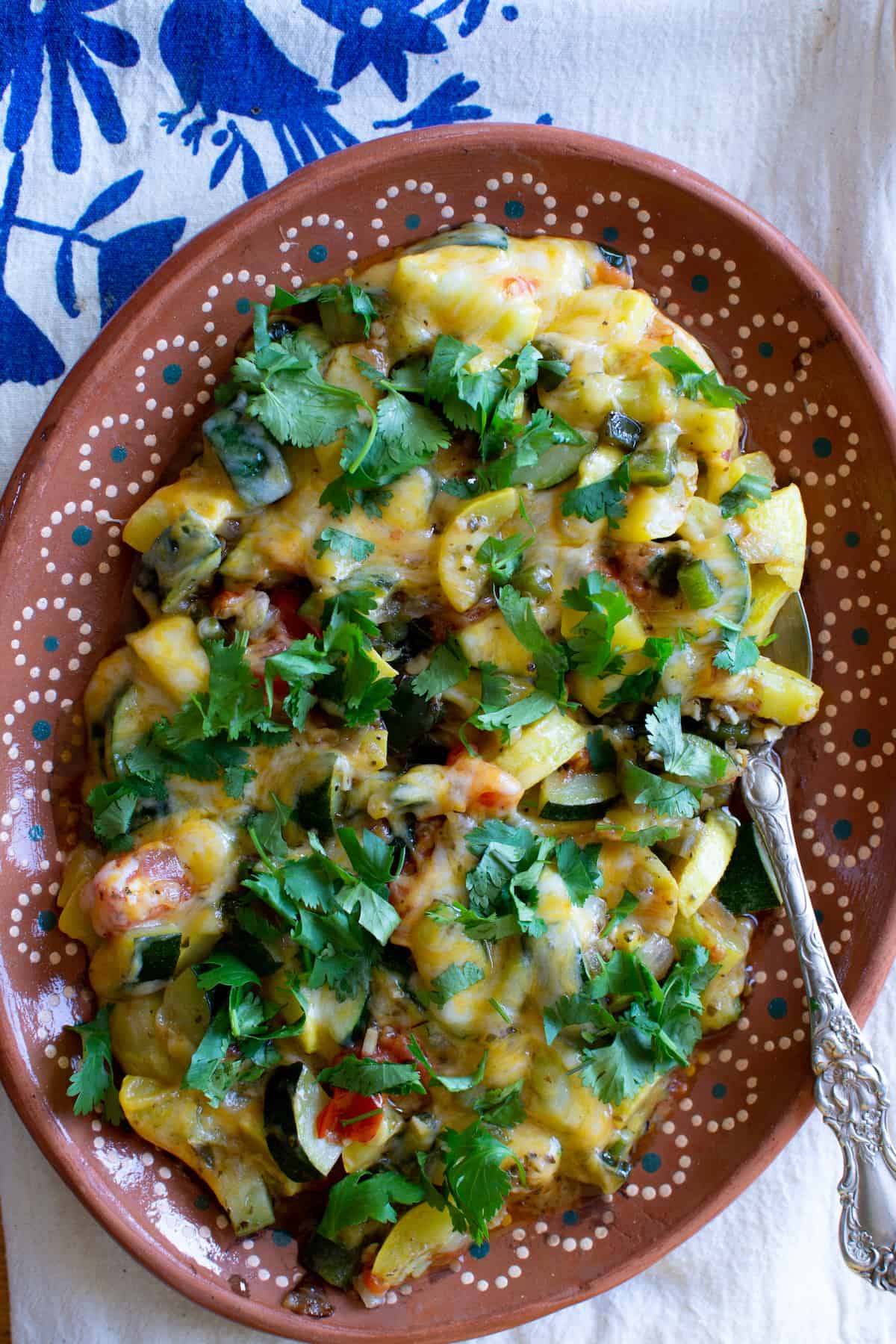 Zucchini is anything but boring when when given the Mexican treatment of a quick sauté then a showering of melty cheese like this classic Calabacitas recipe. #calabacitas #zucchinirecipe #vegetarianmexican #mexicanfood #holajalapeno