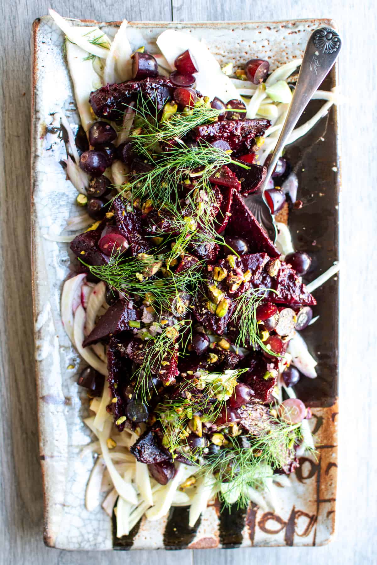 This Grape-Roasted Beet Salad with Serrano Pepper Dressing is a feast for the senses! Sweet, crunchy California grapes not only add texture and flavor to the final salad but also make a delicious marinade for the roasted beets. This is the salad that will elevate your next get-together. #beetsalad #spicysaladdressing #beetsaladdressing #ad