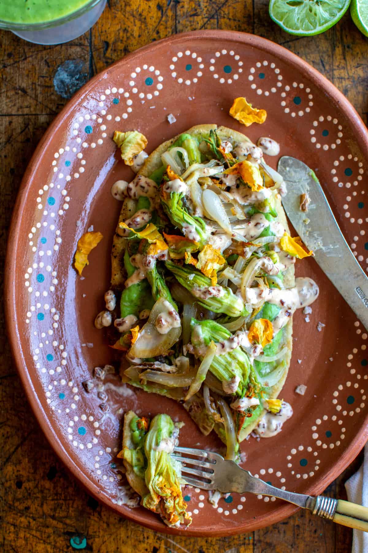 This plant-based Huaraches recipe takes you step-by-step through how to make these heavenly bean-filled masa cakes topped with tomatillo salsa, sautéed squash blossoms, and chipotle aioli. Gluten-free and vegan-adaptable! #holajalapeno #huarachesrecipe #mexicanfood #squashblossoms