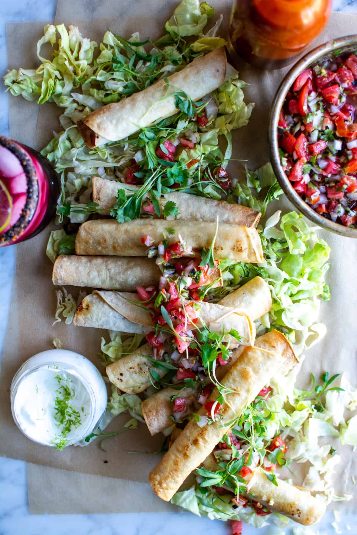 These plant-based taquitos are a real crowd pleaser! Made with sautéed poblano peppers, sweet corn, and creamy queso fresco. Pan-fried, baked, or air-fried they are delicious anyway you cook them. Instructions for all three methods included. #holajalapeno #taquitos #plantbased #flautas