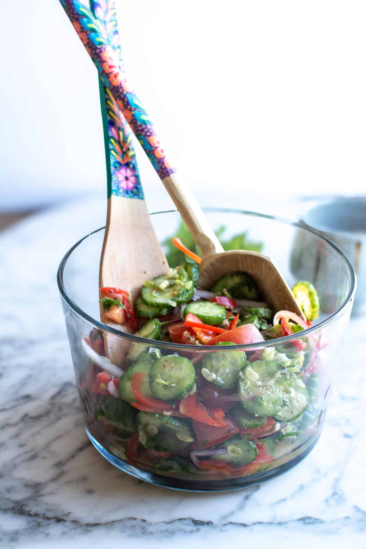 A glass bowl filled with Mexican cucumber recipe