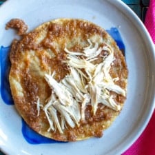 An entomatada filled with chicken on a plate.