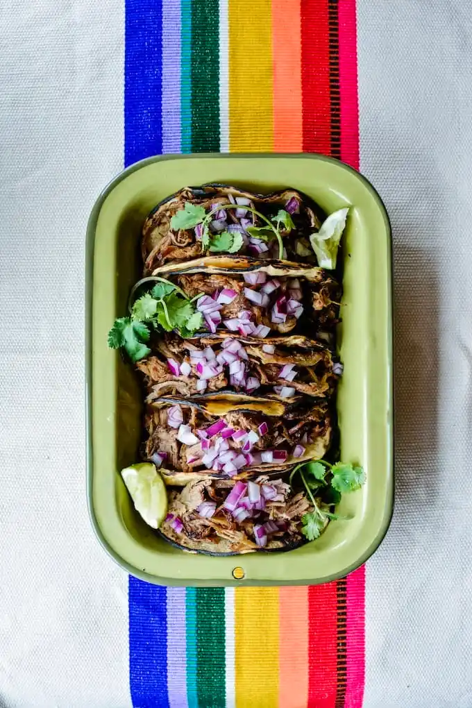 Several tacos in a green dish for Cinco de Mayo