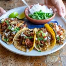 A plate of mushroom carnitas tacos