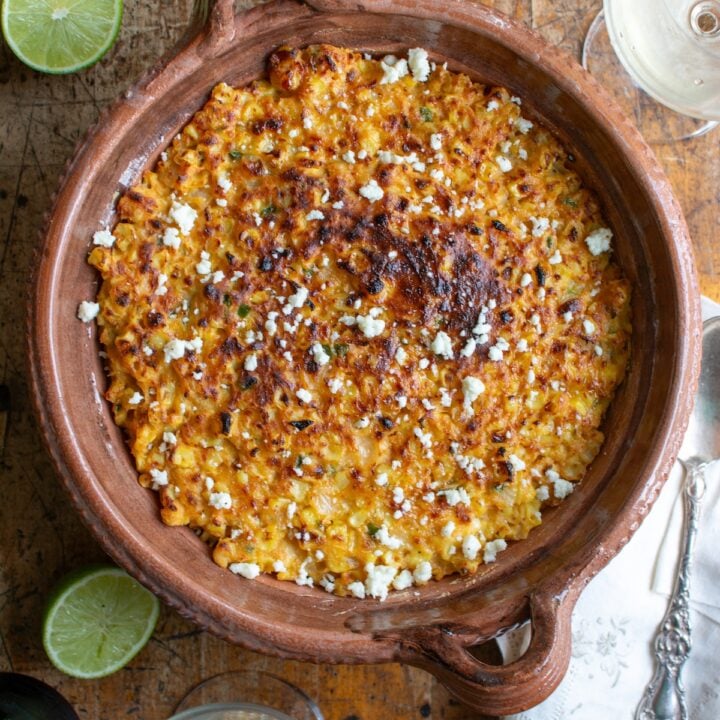 The corn casserole in a dish on a wood table