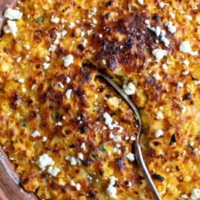 mexican corn casserole recipe with a spoon in the casserole