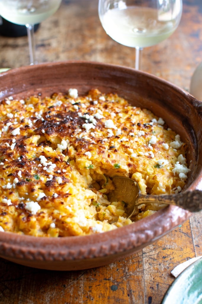mexican corn casserole with a scoop taken out of it