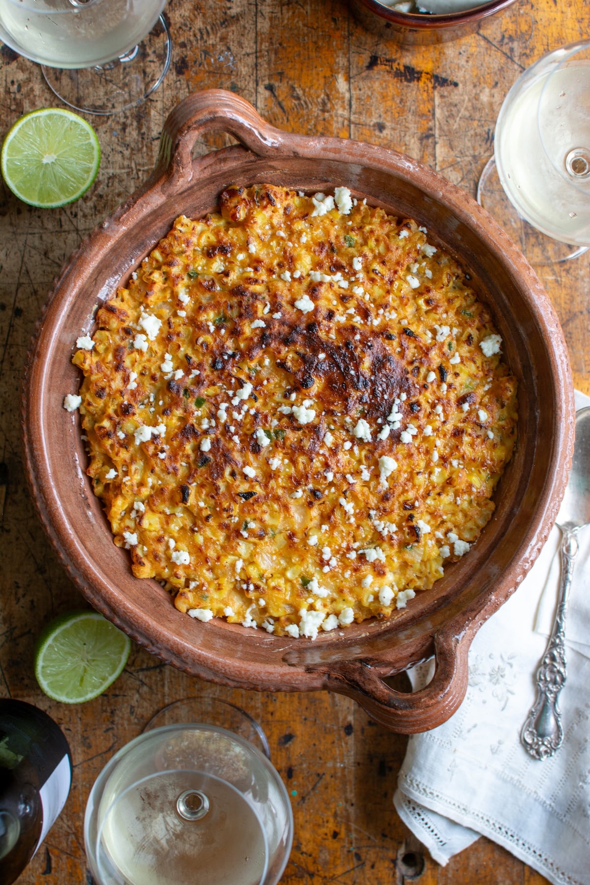 The corn casserole in a dish on a wood table