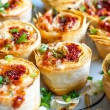 The choriqueso pinwheel bites on a white platter