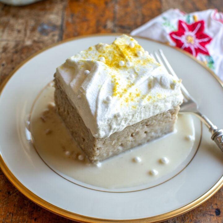 A slice of eggnog tres leches cake on a plate