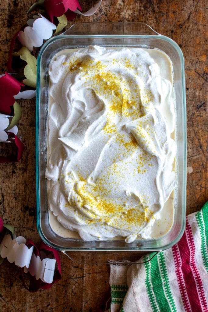An eggnog tres leches cake on a wood table 