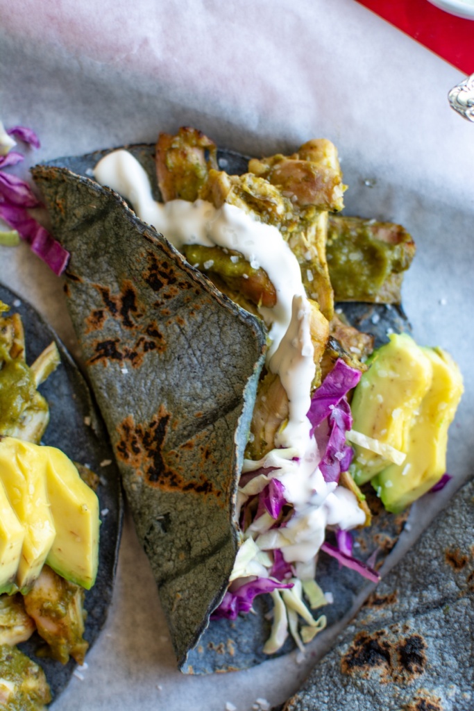 sheet pan chili verde chicken tacos on a piece of parchment paper