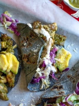 several chili verde chicken tacos on a sheet pan
