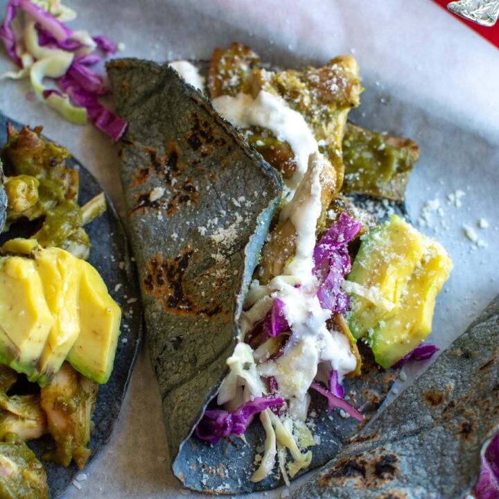 several chili verde chicken tacos on a sheet pan