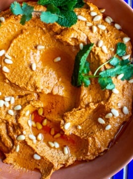 Chile goat cheese dip topped with pine nuts