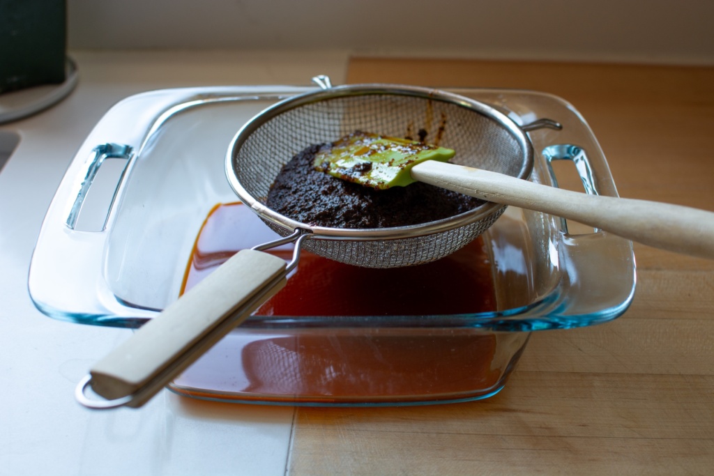 the chili oil draining into a baking dish. 