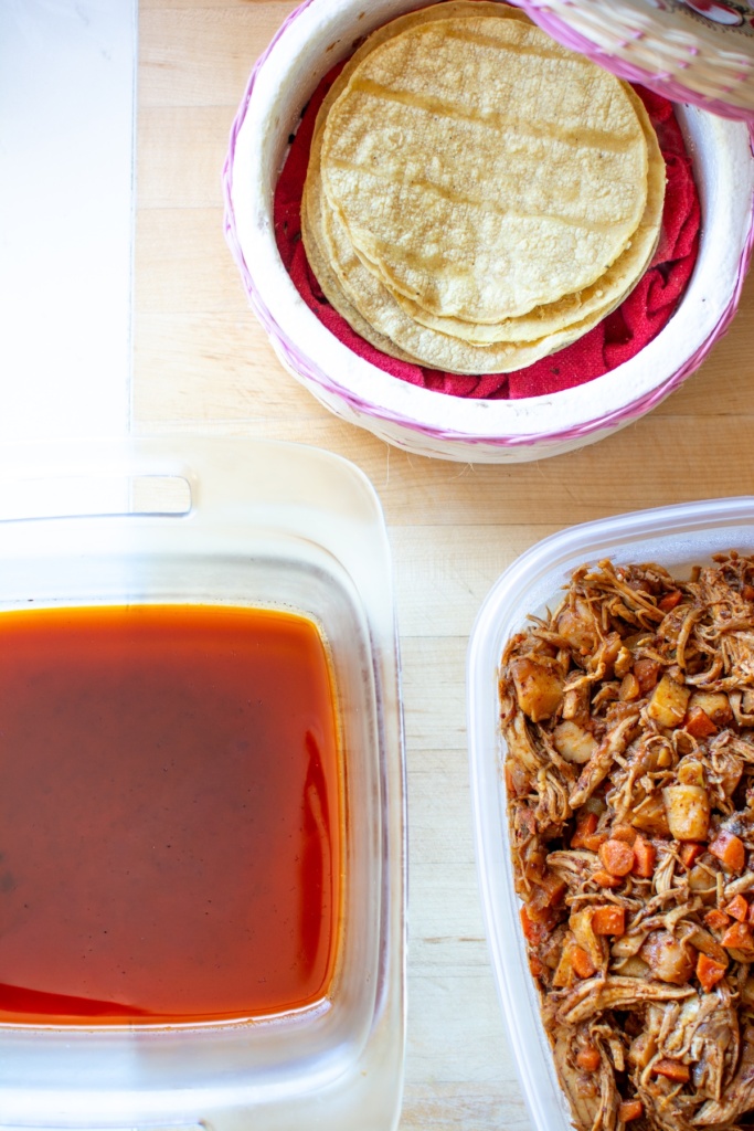 The tortillas, chili oil, and filling in separate containers. 